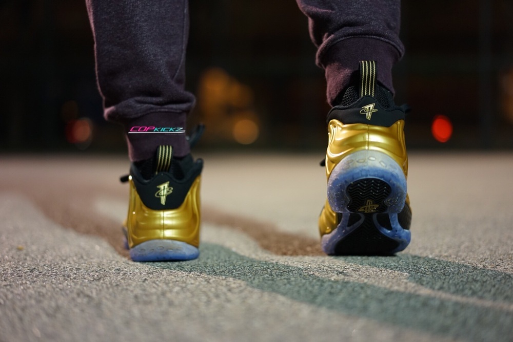 black and gold foams on feet