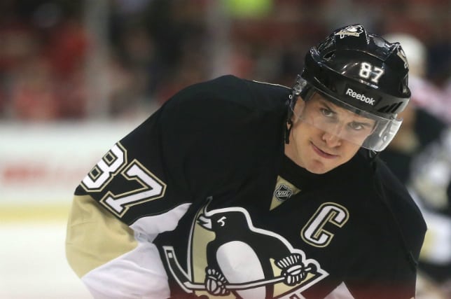 Watch Sidney Crosby pick top corner while being hauled to the ice