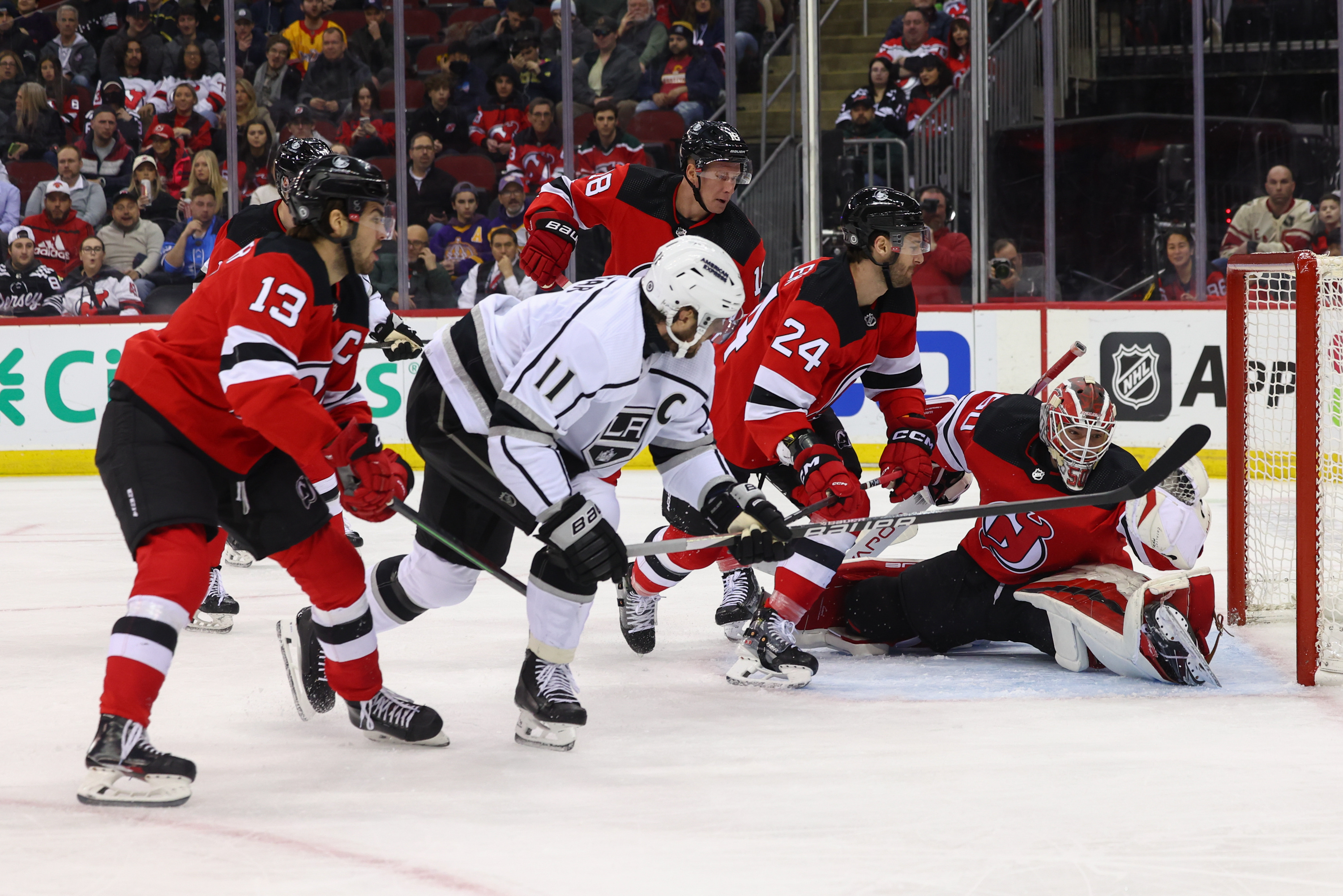 Feb 15, 2024; Newark, New Jersey, USA; New Jersey Devils goaltender Nico Daws (50) makes a glove save on Los Angeles Kings center Anze Kopitar (11) during the first period at Prudential Center. Mandatory Credit: Ed Mulholland-USA TODAY Sports - Devils Come Up Short Against Kings, Fall 2-1