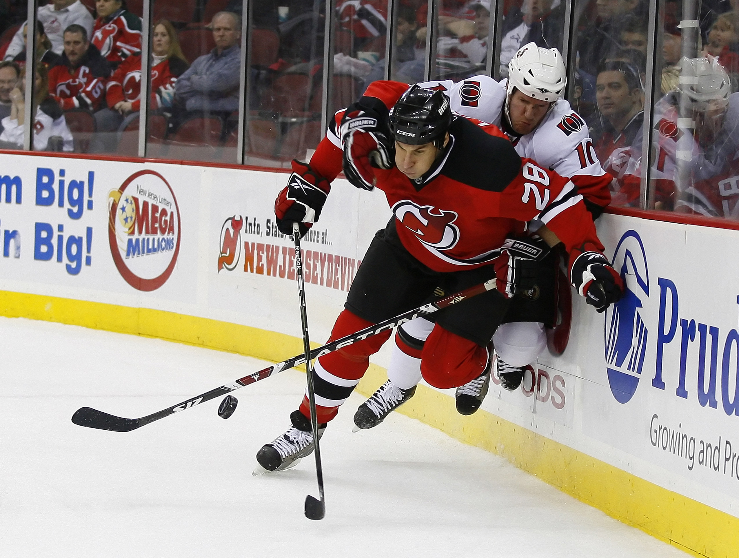 Jan 4, 2008; Newark, NJ, USA; Ottawa Senators right wing Shean Donovan (10) hits New Jersey Devils defenseman Jay Leach (28) during the first period at the Prudential Center. Mandatory Credit: Ed Mulholland-USA TODAY Sports - Former Devils Defenseman Jay Leach Named Bruins Assistant Coach