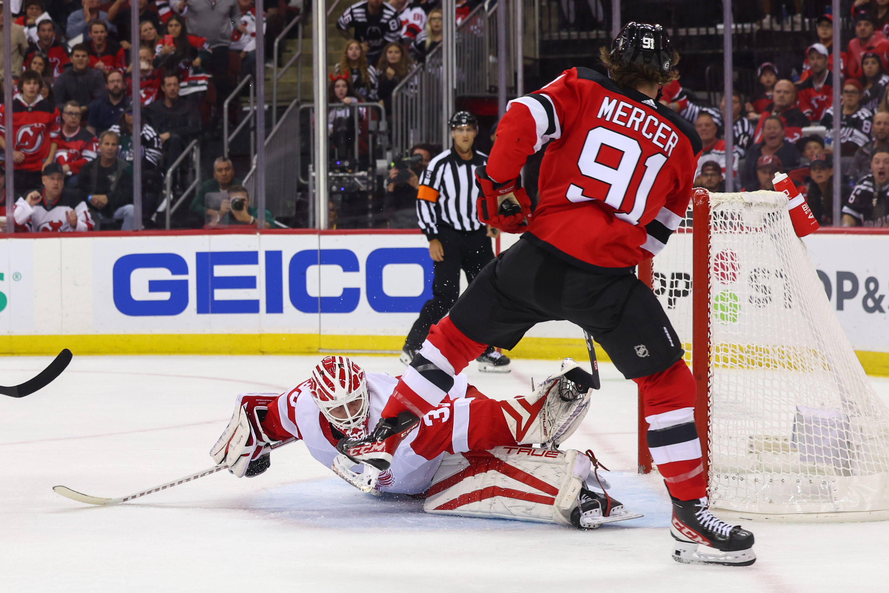 Oct 12, 2023; Newark, New Jersey, USA; Detroit Red Wings goaltender Ville Husso (35) makes a save on New Jersey Devils center Dawson Mercer (91) during the second period at Prudential Center. Mandatory Credit: Ed Mulholland-USA TODAY Sports - Devils' Dawson Mercer Continues to Stay Positive As He Searches for First Goal of the Season