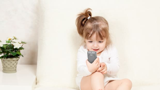 toddler girl with phone