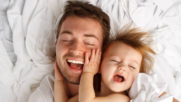 father and toddler laughing