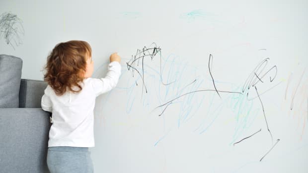 kid drawing on wall