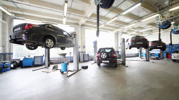 cars in mechanic shop on lifts