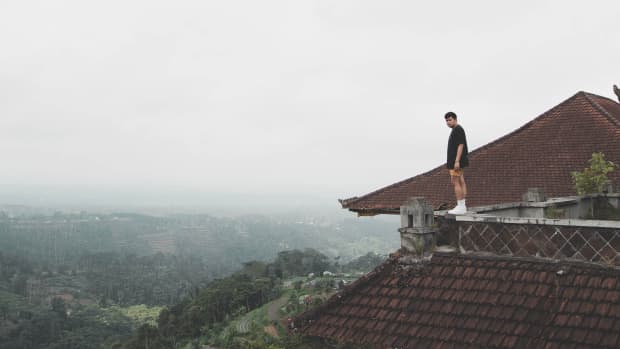 A man stands on the rooftop of an abandoned hotel in Bali