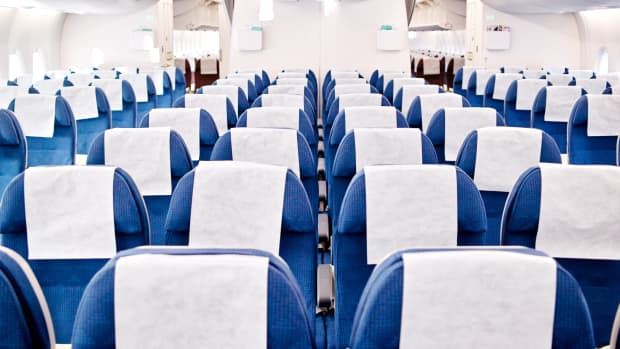 A spacious empty airplane cabin with rows and rows of seats