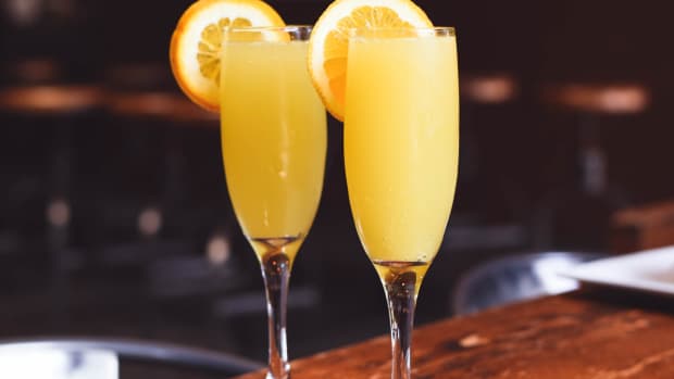 Two mimosas in the foreground, a club or bar in the background