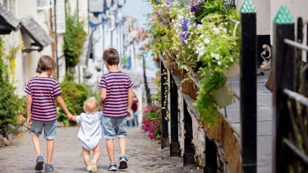 Children walking down the quiet cobbled streets of Clovelly in Devonshire, England
