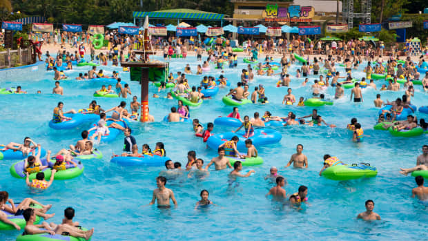 Visitors swim in a busy wave pool at a water park in Guangzhou, China