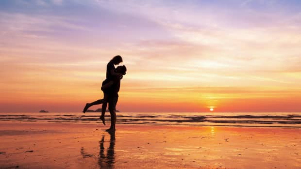 Couple embracing on the beach at sunset