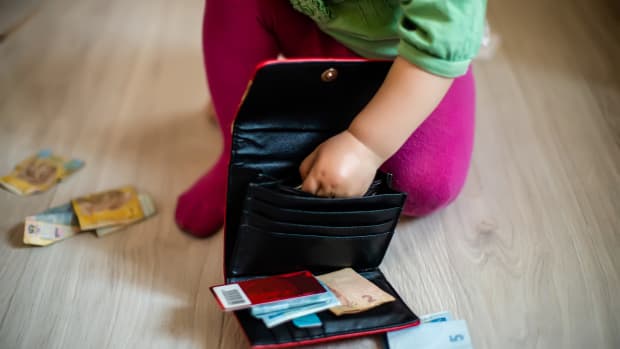 toddler with purse and money