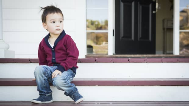 toddler boy on front porch