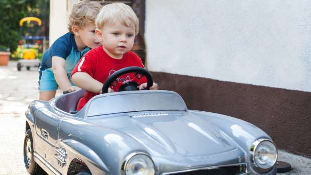 toddler boy in toy car