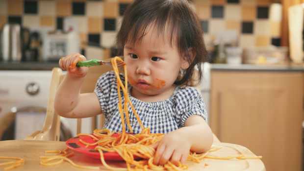 toddler eating spaghetti