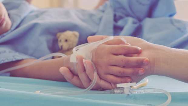 kid in hospital holding hands