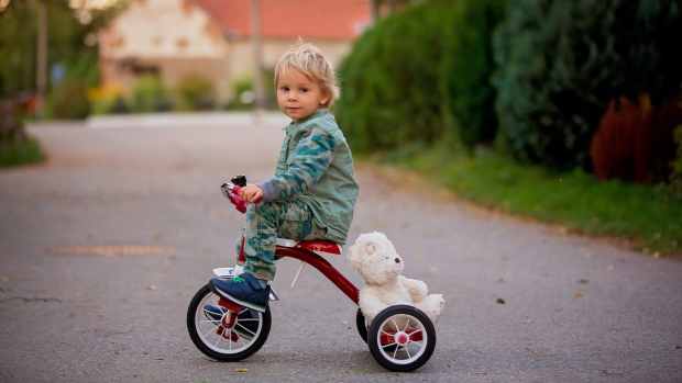 boy on tricycle