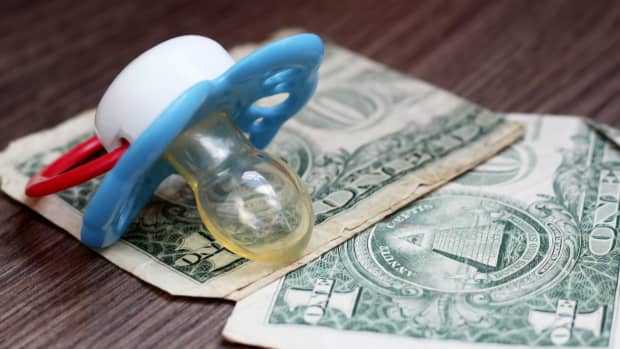a pacifier with dollar bills