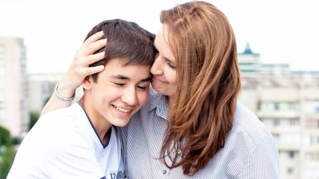 mom hugging teenage son