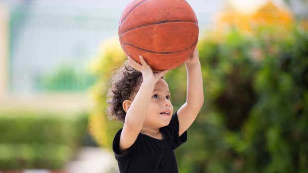 toddler boy playing basketball