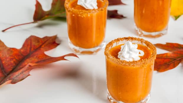 Orange-colored shot with whipped cream on top