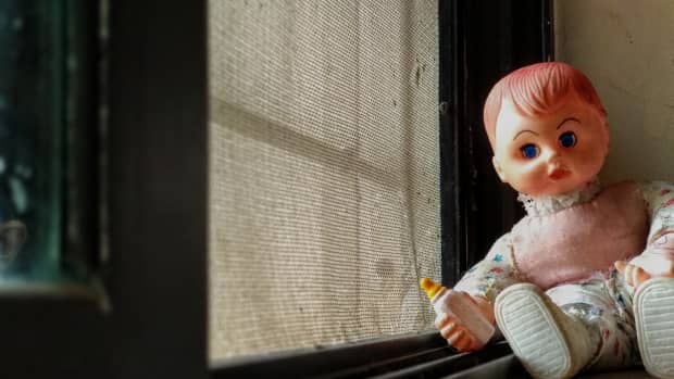 baby doll by window