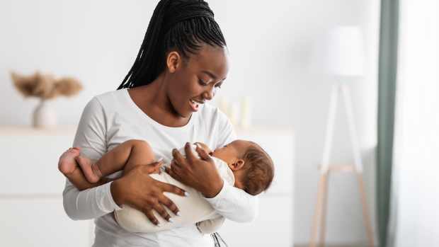 A mom holds her baby close while singing a lullaby