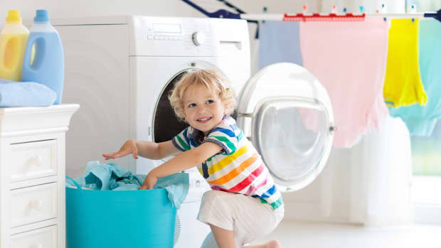 little boy doing laundry