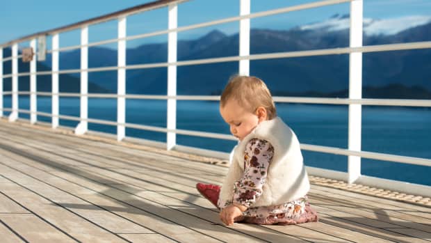 baby sitting on cruise ship deck
