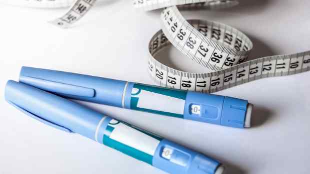 Injectable weight loss drugs and a tape measure.