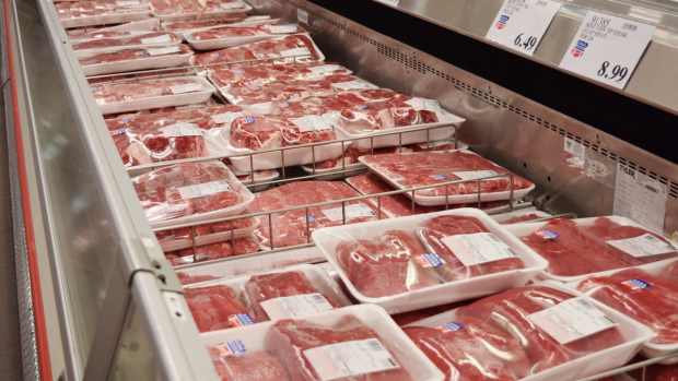 A refrigerator case filled with red meat at Costco.