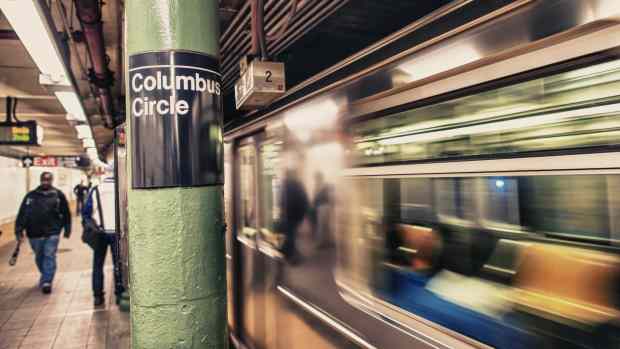 A NYC subway train speeding through Columbus Circle station