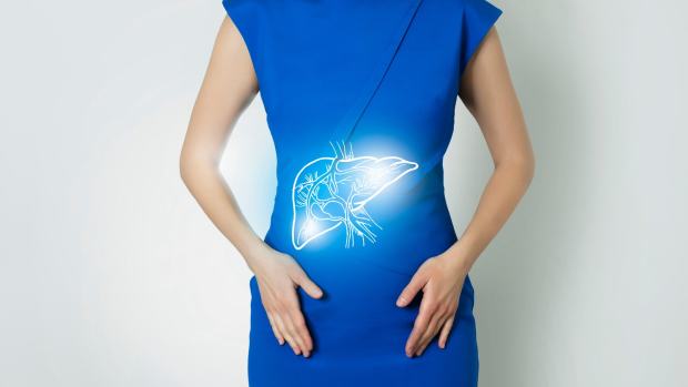 A woman wearing a blue dress with the outline of a liver over her abdomen.