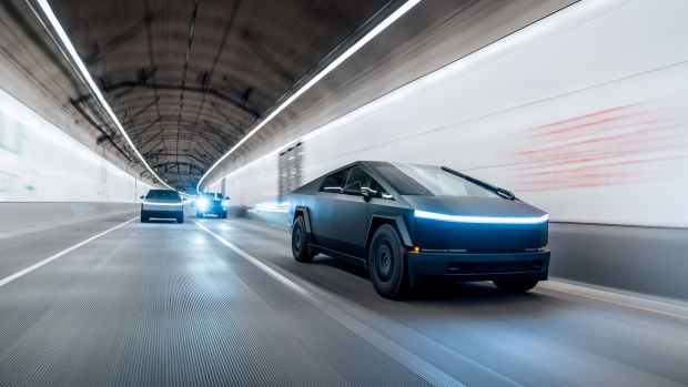 Tesla Cybertrucks driving through a tunnel