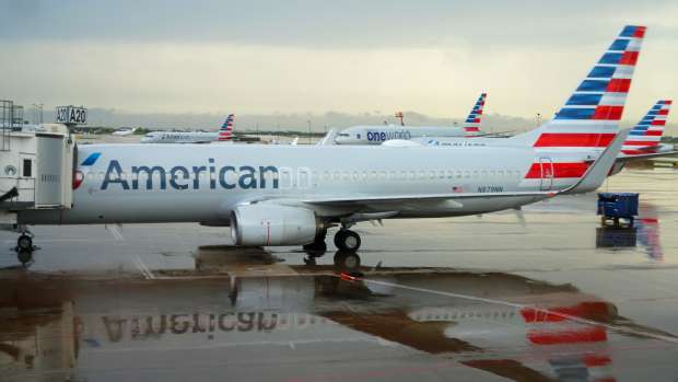 An American Airlines plane on a rainy tarmac at DFW
