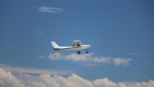 Small white plane in flight