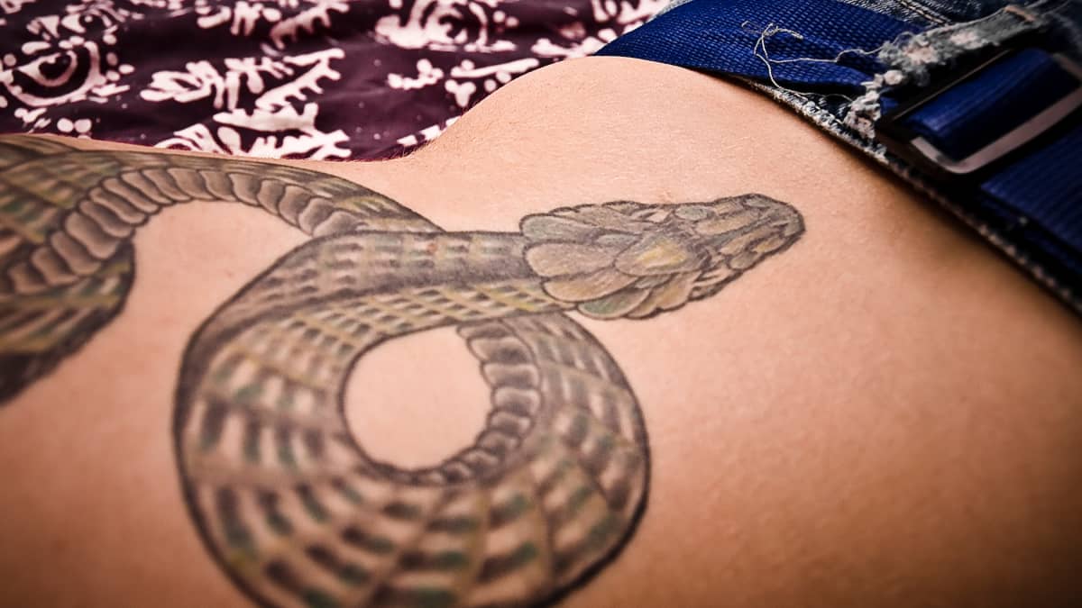 Snake tattoo on the left thigh