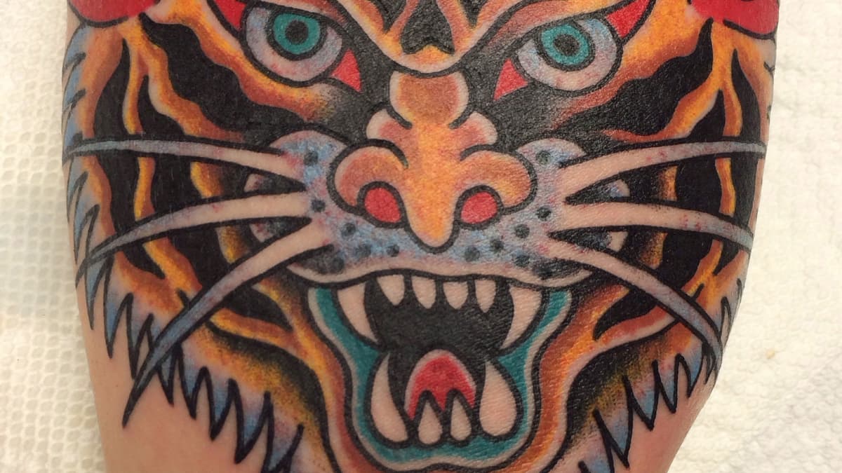 Matching tiger panther tattoo.