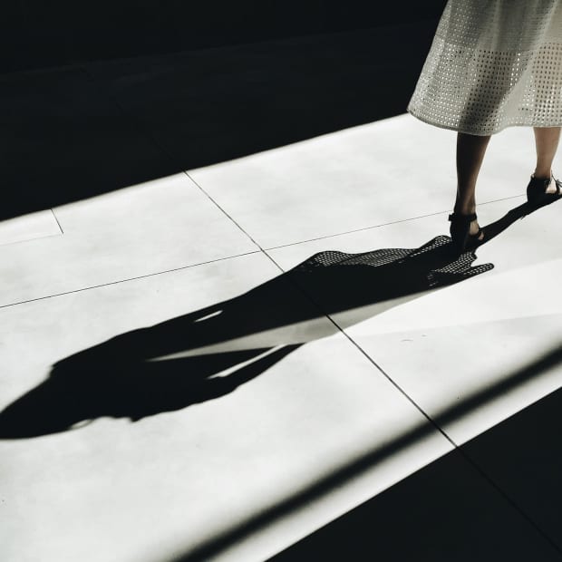 shadow of a woman in a gauzy white dress