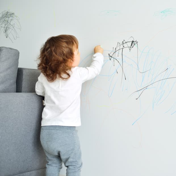 kid drawing on wall