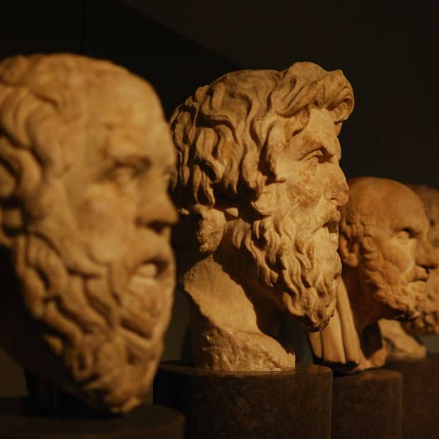 Busts of Greek philosophers, including Aristotle