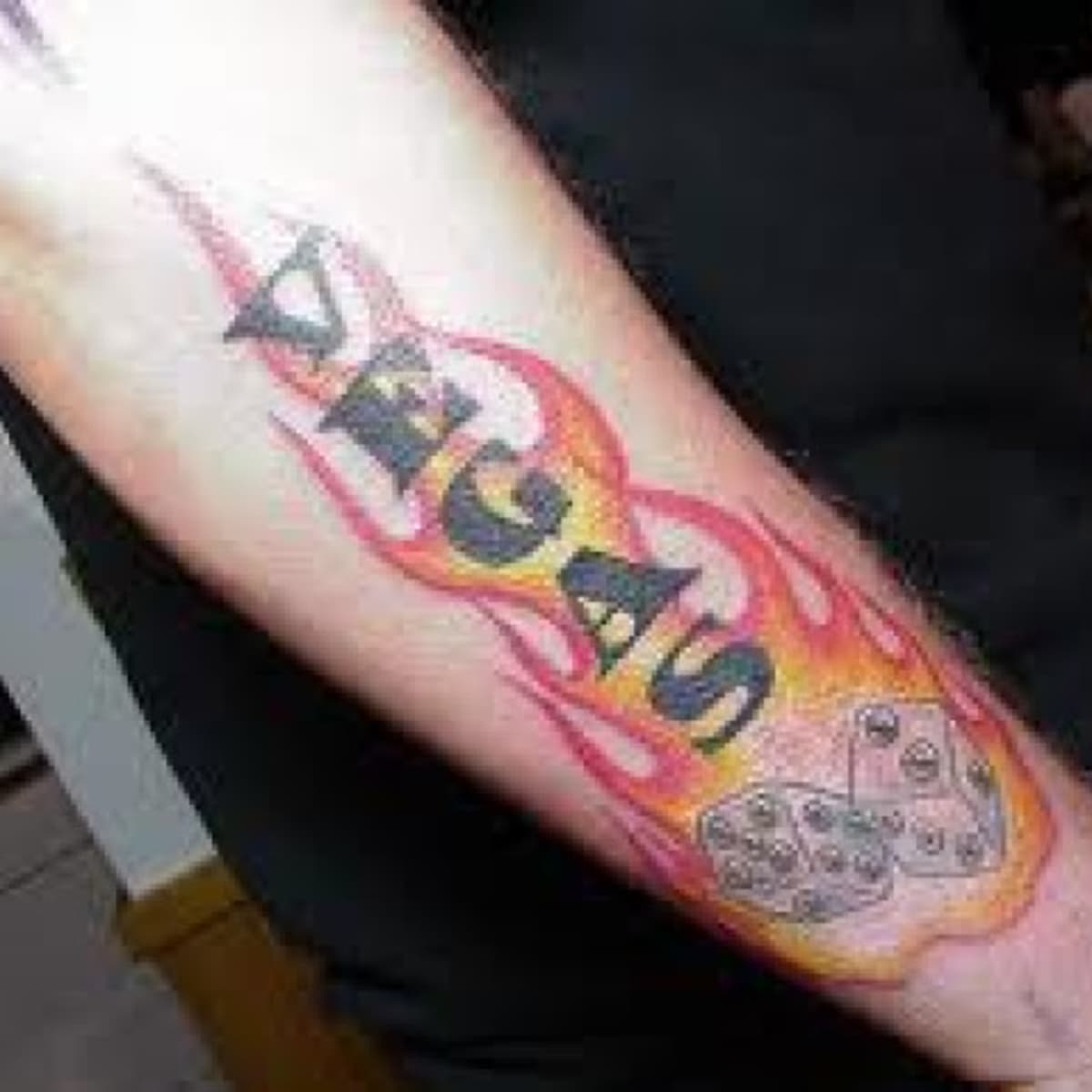 MInimalistic dice tattoo located on the forearm