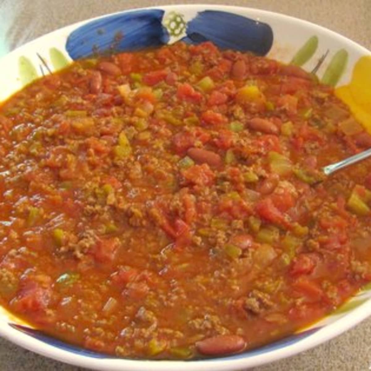 https://images.saymedia-content.com/.image/ar_1:1%2Cc_fill%2Ccs_srgb%2Cfl_progressive%2Cq_auto:eco%2Cw_1200/MTgzNTY4Nzg1MzA1ODM4NjMw/my-mouthwatering-chili-recipe.jpg