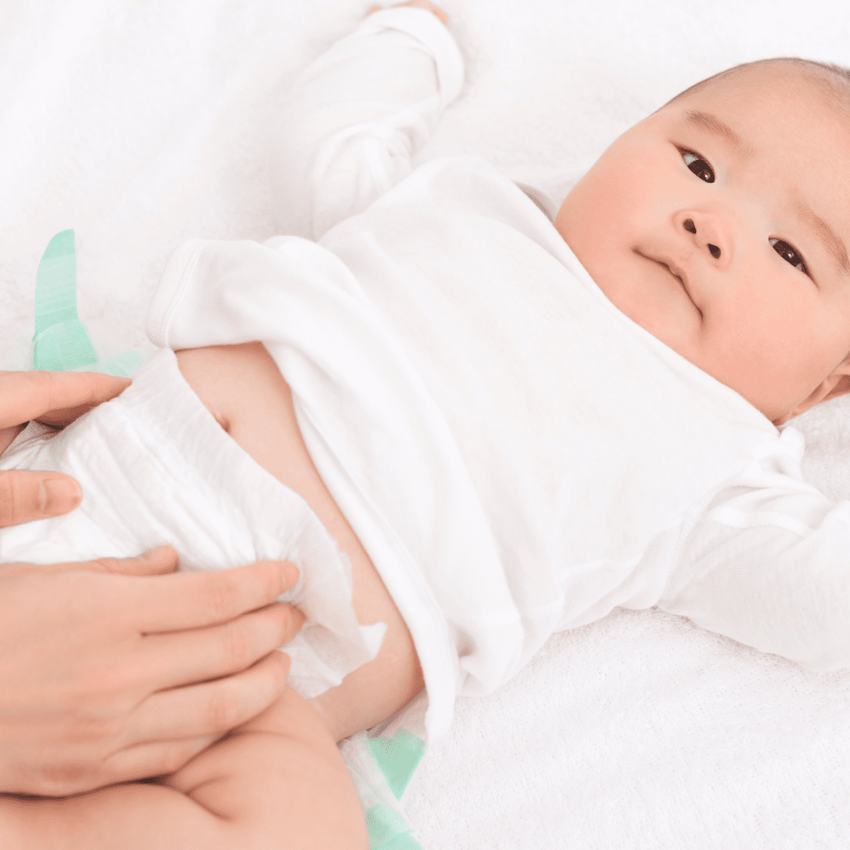 Infant wearing Huggies baby diaper with yellow line turning blue