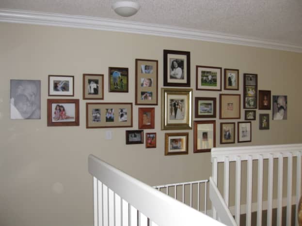 My family photo wall display.  I chose to use all gold and brown wood tones, with the exception of the two unframed canvas prints.  I have found that this overall shape is easily tweaked if I decide I want to add a couple more frames here and there.