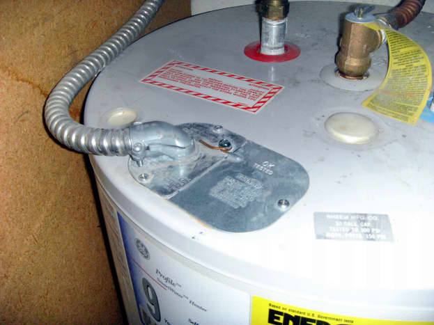 Electrical cover plate: Note the bare ground wire fastened to the top of the plate.