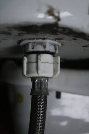 This is where the hose meets the tank. The large white portion with blades is the part of the hose you will unscrew off to disconnect the water hose.