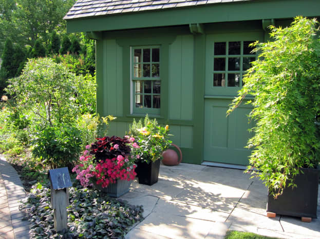 This quaint cottage provides a beautiful storage and work space for the test garden.