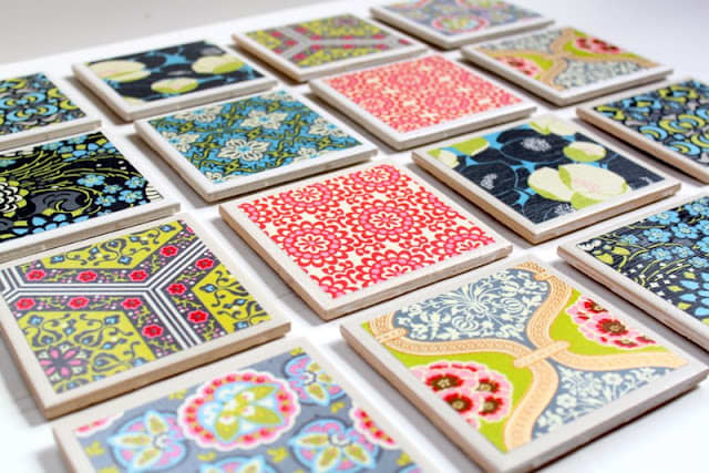 Tile coasters covered with pretty papers.