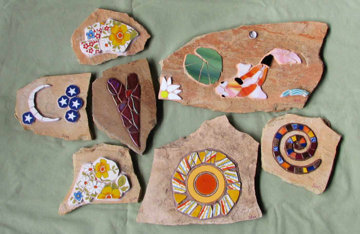 Mosaic koi, spiral, heart, sun, moon, stars, and flower garden stones.